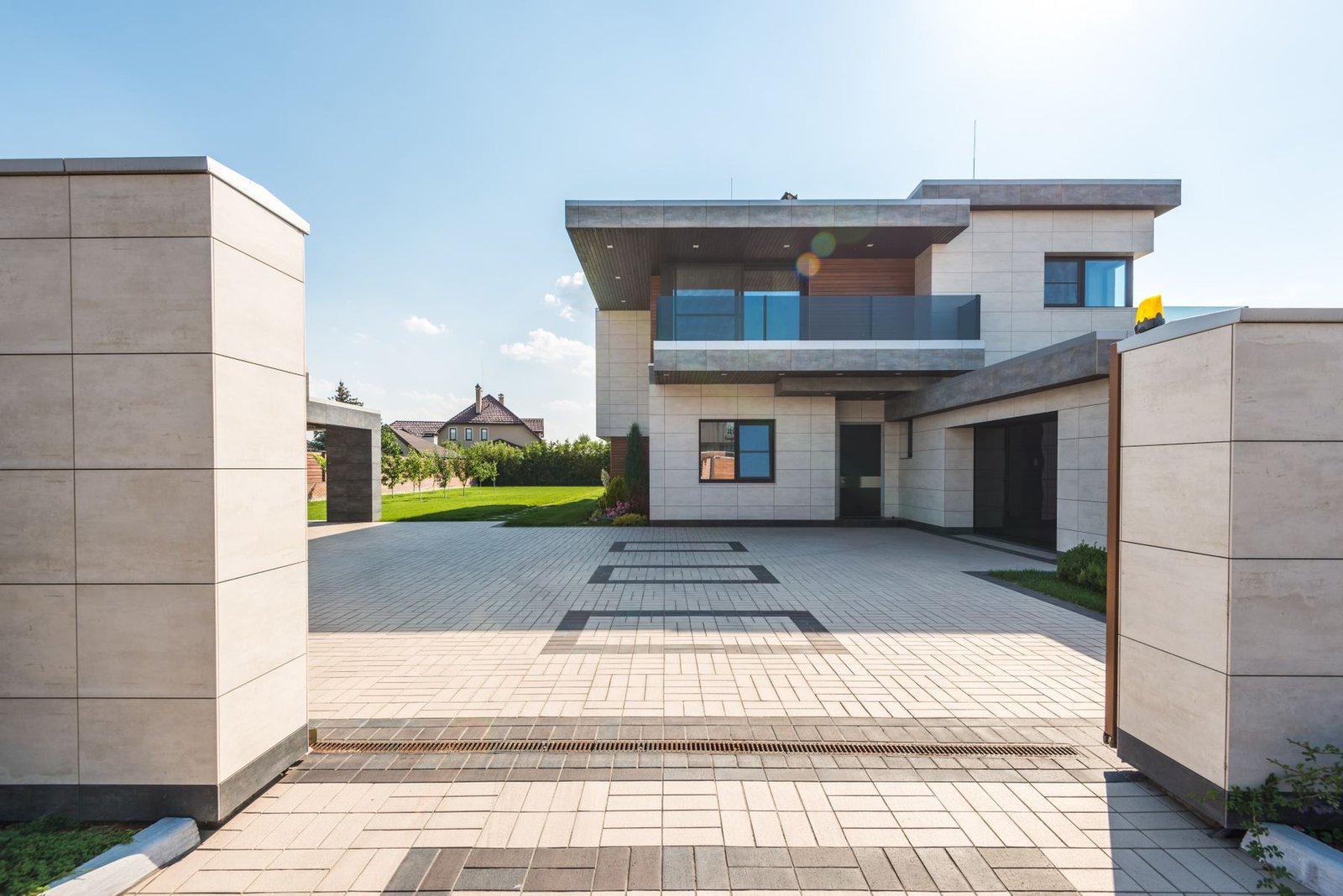 Two-story luxury house with a spacious driveway and garden - illustrative stock photo