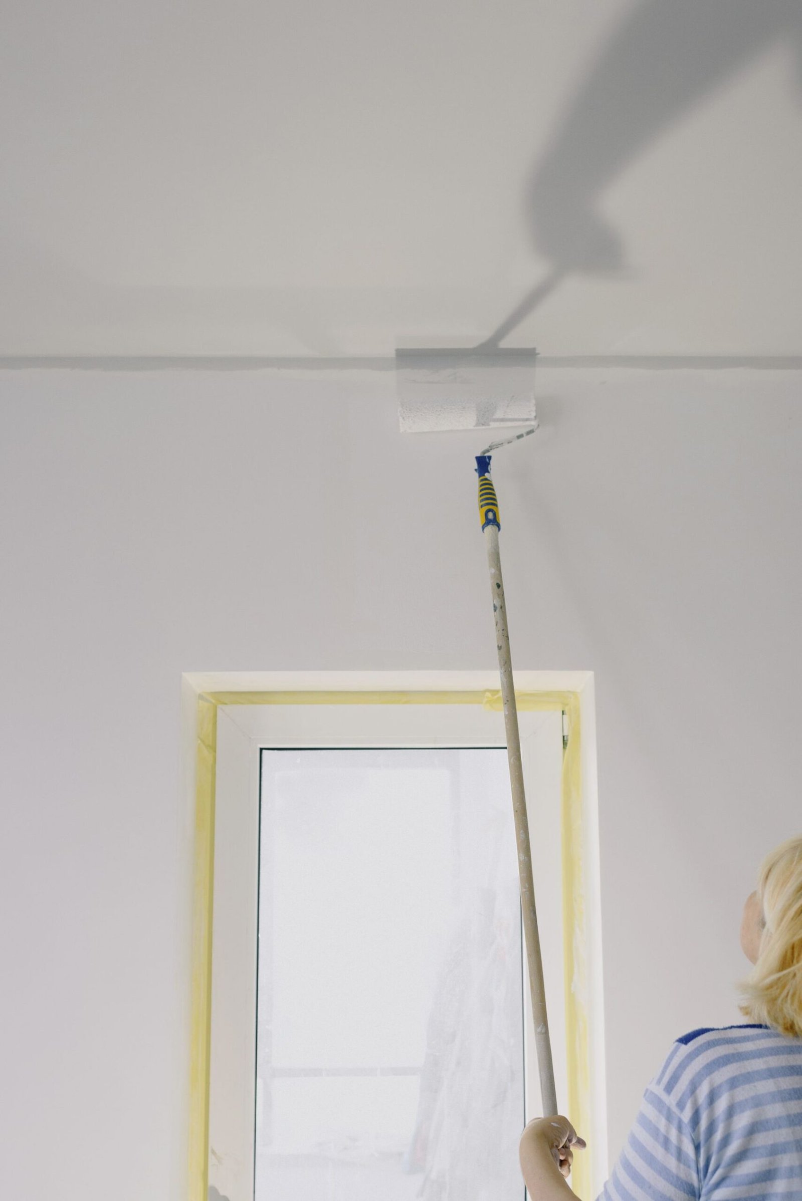 Close-up of wall painting with a roller - illustrative stock photo