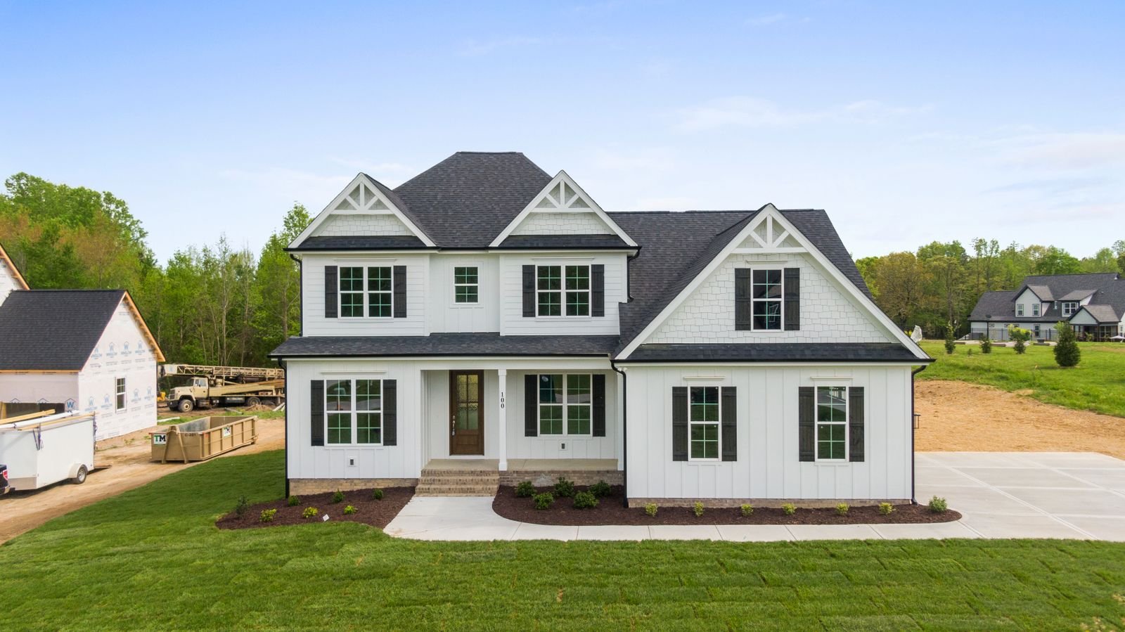 Contemporary American home with clean exterior finishes and a landscaped lawn - illustrative stock photo