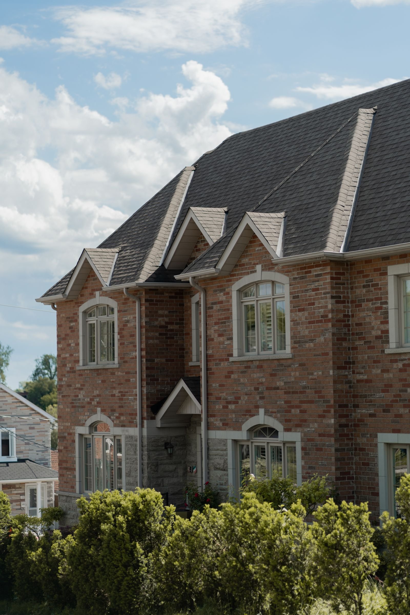 Detached house exterior with landscaped surroundings - illustrative stock photo
