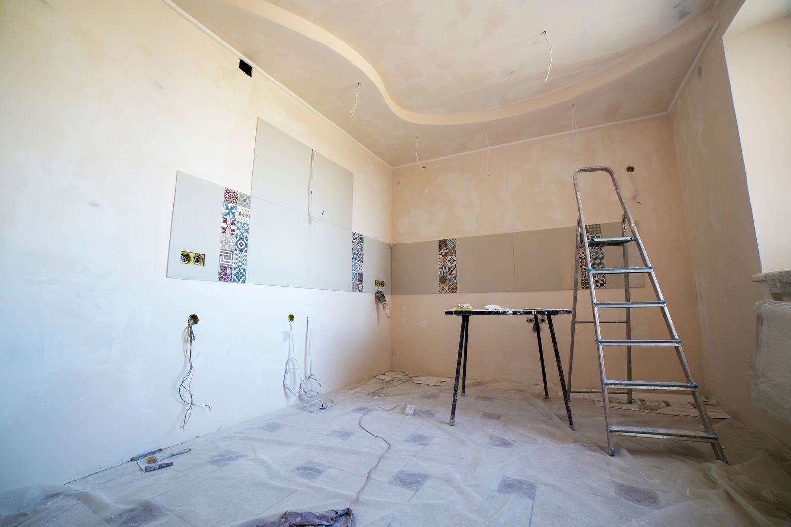Interior room being prepared for renovation with ladders and materials - illustrative stock photo