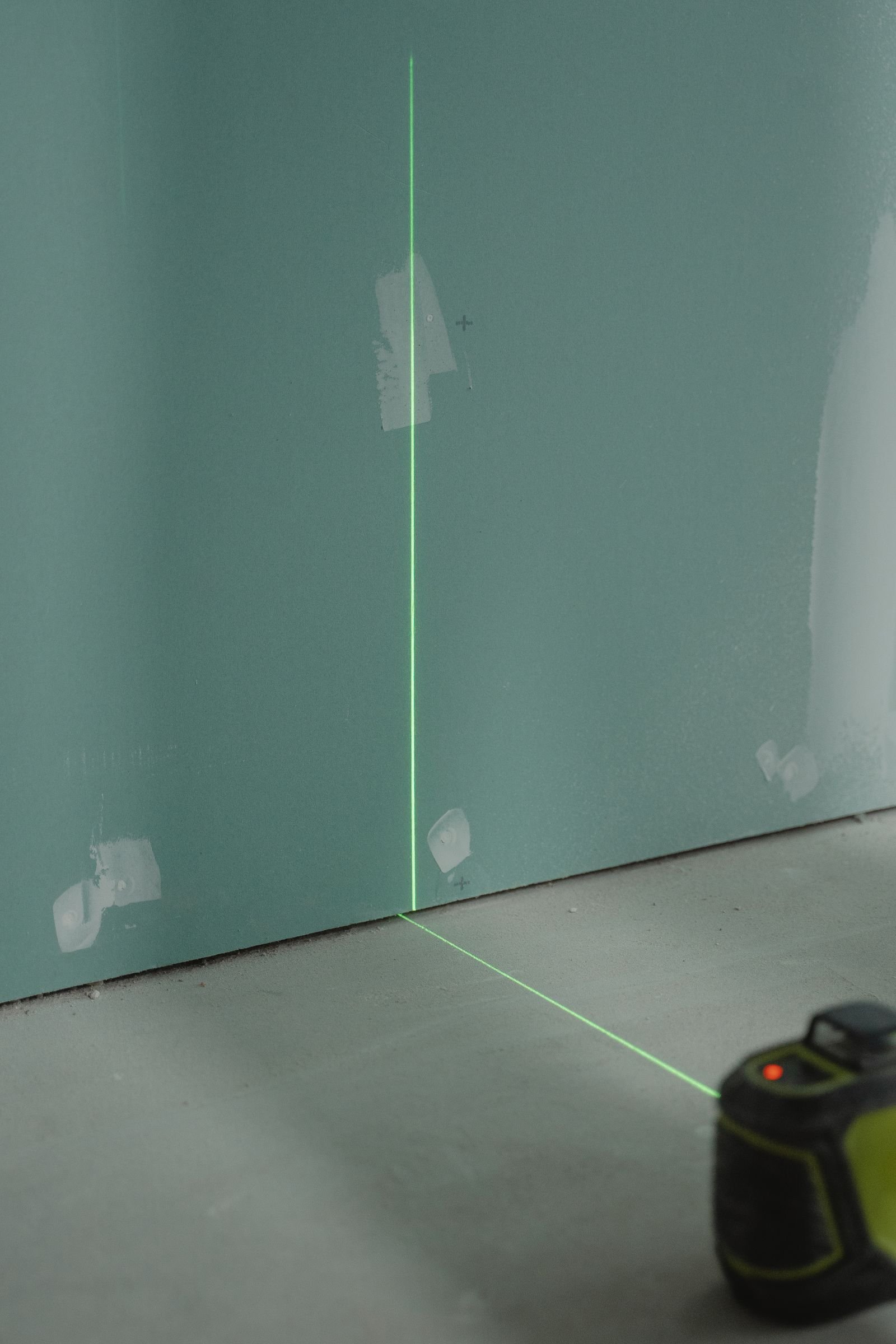 Laser alignment tool projecting a line onto an interior wall - illustrative stock photo