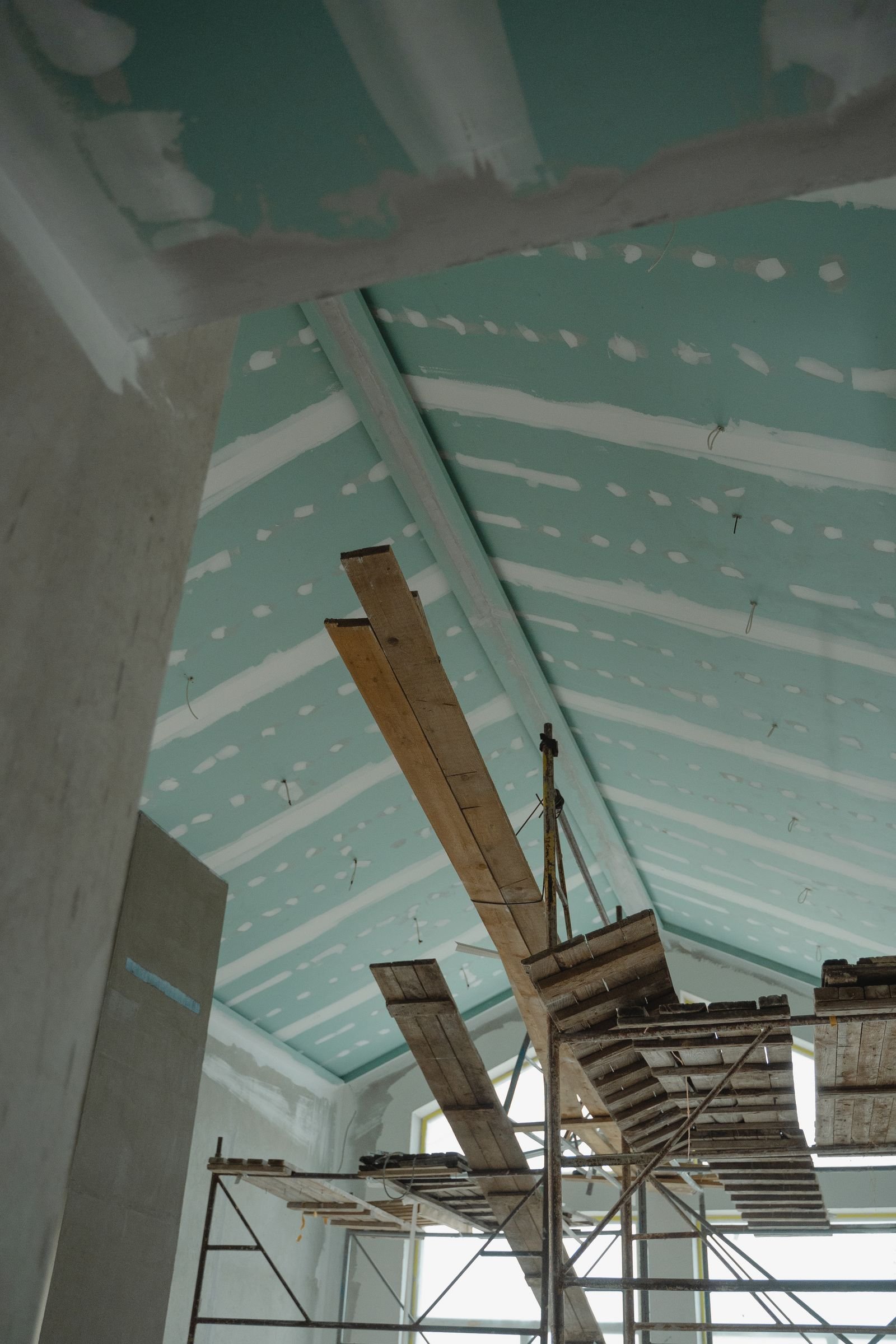 Interior renovation with ceiling boards, scaffolding and materials - illustrative stock photo