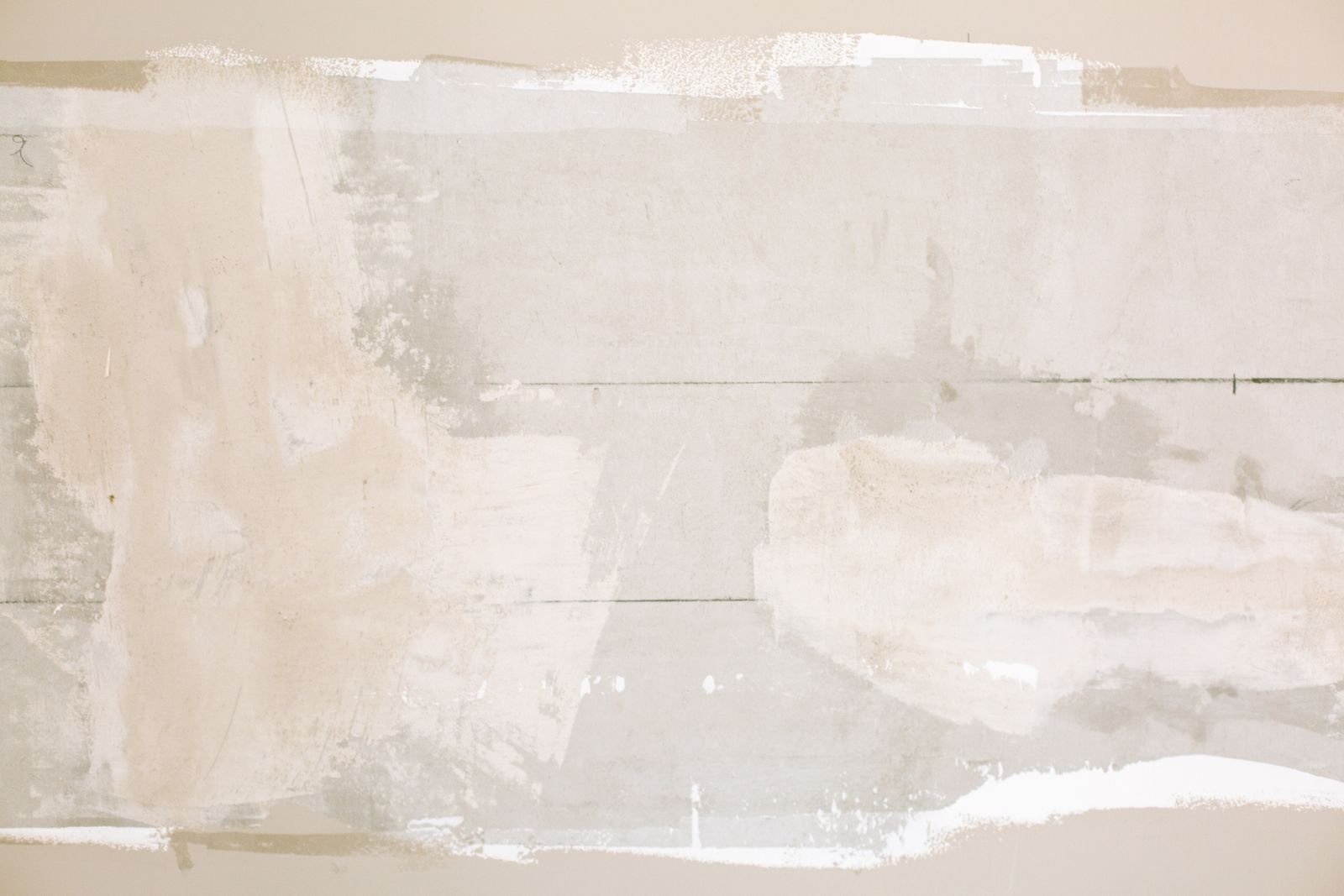 Unfinished interior wall showing plaster and paint textures - illustrative stock photo