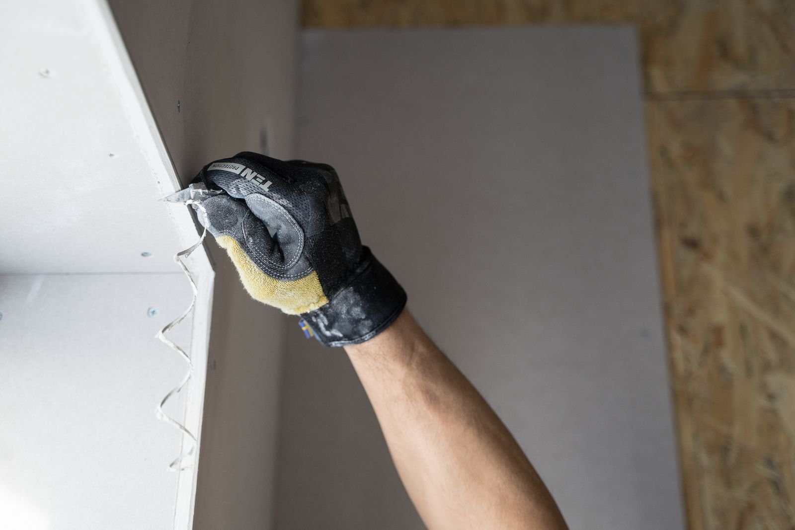 Worker wearing gloves during interior renovation - illustrative stock photo