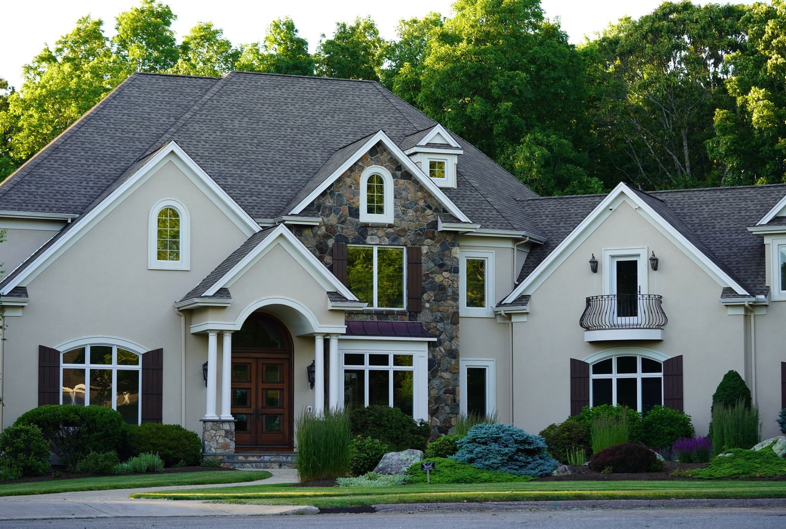 Large suburban house surrounded by greenery - illustrative stock photo