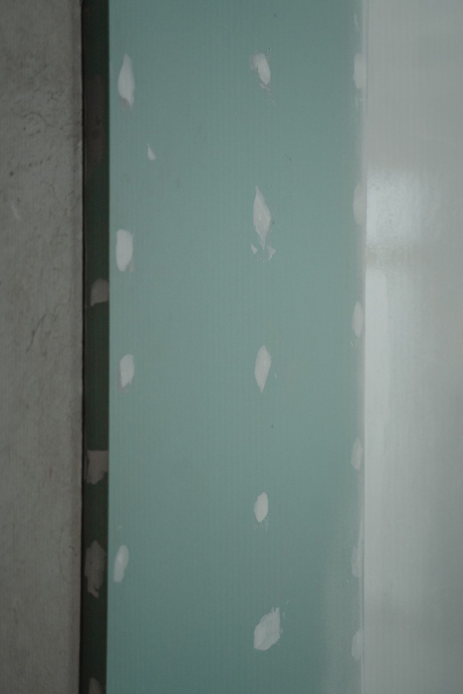 Patched drywall ready for finishing and paint - illustrative stock photo